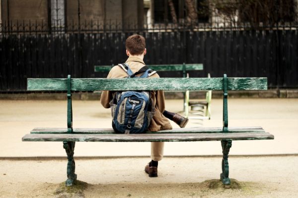 Solo traveler sitting on bench in Paris